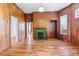 Charming living room with hardwood floors, wood-paneled walls, and a unique green-tiled fireplace at 126 E Henderson St, Salisbury, NC 28144