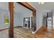 Open living room with hardwood floors, a vintage fireplace, and a view of the staircase at 126 E Henderson St, Salisbury, NC 28144