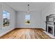 Spacious living room with hardwood floors, large windows providing natural light, and a vintage fireplace at 126 E Henderson St, Salisbury, NC 28144