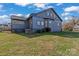 Rear view of a blue two-story home with a well-maintained lawn and a classic architectural style at 126 E Henderson St, Salisbury, NC 28144