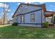 Side view of a two-story home featuring blue siding, classic black window trim, and lush green landscaping at 126 E Henderson St, Salisbury, NC 28144