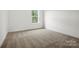 Bedroom featuring plush carpeting, neutral paint, and a single double hung window at 1282 Kindness Nw Ct, Concord, NC 28027