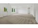 Expansive bonus room featuring plush carpeting, neutral paint, and an exterior door to the backyard at 1282 Kindness Nw Ct, Concord, NC 28027