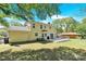 Spacious backyard featuring a charming yellow two-story home and a large deck, perfect for outdoor entertaining at 1308 Spring Lake Dr, Gastonia, NC 28054