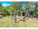 Landscaped backyard featuring an outdoor firepit, seating, green grass, and mature trees at 1308 Spring Lake Dr, Gastonia, NC 28054