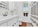 Bathroom featuring white vanity, shiplap walls, chrome fixtures, and a window for natural light at 1308 Spring Lake Dr, Gastonia, NC 28054