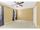 Cozy bedroom with light-colored carpet, a ceiling fan, and a window with gray curtains at 1308 Spring Lake Dr, Gastonia, NC 28054