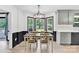 Dining room with wainscoting, modern light fixture and large windows, perfect for entertaining guests at 1308 Spring Lake Dr, Gastonia, NC 28054