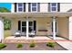 Inviting front porch with comfortable seating and meticulously maintained landscaping, offering curb appeal at 1308 Spring Lake Dr, Gastonia, NC 28054