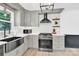 Modern kitchen with stainless steel appliances, quartz countertops, and gray cabinetry at 1308 Spring Lake Dr, Gastonia, NC 28054