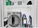 Laundry room features a modern front-load dryer with supplies neatly arranged on a shelf above at 1308 Spring Lake Dr, Gastonia, NC 28054