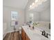 Bathroom featuring double sinks, wood cabinets, and a large mirror at 14802 Rolling Sky Dr, Charlotte, NC 28273