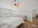 Light-filled bedroom with hardwood floors, ceiling fan, and ample closet space at 14802 Rolling Sky Dr, Charlotte, NC 28273