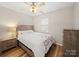 Cozy bedroom with natural light, ceiling fan, and wood floors at 14802 Rolling Sky Dr, Charlotte, NC 28273