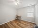 Bright bedroom features a ceiling fan, wood floors, and a window for natural light at 14802 Rolling Sky Dr, Charlotte, NC 28273