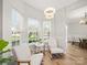 Inviting breakfast nook with large windows and view to the dining room at 14802 Rolling Sky Dr, Charlotte, NC 28273