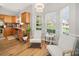 Sunlit breakfast nook featuring rocking chairs, a view to the kitchen, and bright windows at 14802 Rolling Sky Dr, Charlotte, NC 28273