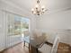Bright dining area with sliding glass door and modern chandelier at 14802 Rolling Sky Dr, Charlotte, NC 28273