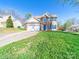 Inviting two-story home with brick details, blue shutters, attached garage, and a well-maintained front yard at 14802 Rolling Sky Dr, Charlotte, NC 28273