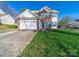 Two-story home with brick details, blue shutters, attached garage, and a well-maintained front yard at 14802 Rolling Sky Dr, Charlotte, NC 28273