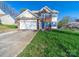 Two-story home with brick details, blue shutters, attached garage, and a well-maintained front yard at 14802 Rolling Sky Dr, Charlotte, NC 28273