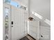 Bright entryway with white door, side window, decorative accents, shoe cabinet and light gray flooring at 14802 Rolling Sky Dr, Charlotte, NC 28273