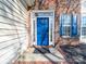 Attractive blue front door surrounded by brick, sidelights and decorative trim with a porch mat at 14802 Rolling Sky Dr, Charlotte, NC 28273