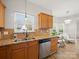 Kitchen with granite countertops and stainless steel appliances is open to the living area at 14802 Rolling Sky Dr, Charlotte, NC 28273