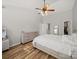 Bright main bedroom with wood floors, ceiling fan, and ensuite bath access at 14802 Rolling Sky Dr, Charlotte, NC 28273