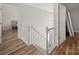 View of stairwell with white railing and wood floors at 14802 Rolling Sky Dr, Charlotte, NC 28273