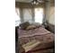 Bright bedroom with comfortable bed, lace curtains, and natural light at 149 Deer Park Rd # D26/27, Mount Gilead, NC 27306