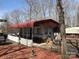 Charming single-story home with a red metal awning, front patio, and white picket fence at 149 Deer Park Rd # D26/27, Mount Gilead, NC 27306