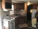 Functional kitchen equipped with a gas range, microwave, and ample cabinet space at 149 Deer Park Rd # D26/27, Mount Gilead, NC 27306