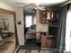 Cozy living room featuring wood cabinets, ceiling fan, and an archway leading into the bedroom at 149 Deer Park Rd # D26/27, Mount Gilead, NC 27306
