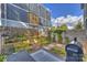 Private backyard retreat with raised garden beds, a charming patio area, and a grill for outdoor entertaining at 1651 Duckworth Ave, Charlotte, NC 28208