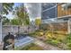 Charming backyard features a dining set, a grill, and raised garden beds, ideal for outdoor relaxation and entertainment at 1651 Duckworth Ave, Charlotte, NC 28208
