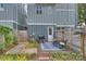Backyard area featuring a dining set, a grill, and stepping stone pathway with a fenced yard, providing a perfect space at 1651 Duckworth Ave, Charlotte, NC 28208