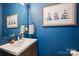 Stylish powder room featuring a modern sink, elegant mirror, and unique blue wall color at 1651 Duckworth Ave, Charlotte, NC 28208