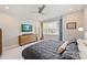 Comfortable bedroom with a large bed, dresser with TV, and bright window at 1651 Duckworth Ave, Charlotte, NC 28208