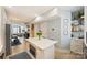 Open-concept kitchen with a center island, stainless appliances, and seamless flow to the living and dining areas at 1651 Duckworth Ave, Charlotte, NC 28208