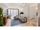 Open living room with a large sectional, TV, and large windows. Access to stairs at 1651 Duckworth Ave, Charlotte, NC 28208