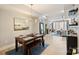 Open concept with dining table and chairs with view to living room, wine shelves, and view to outside balcony at 1651 Duckworth Ave, Charlotte, NC 28208