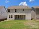 New home backyard featuring a green lawn and a covered patio space accessible through glass doors at 2022 Puddle Pond Rd, Indian Trail, NC 28079