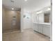 Elegant bathroom with a glass-enclosed shower, neutral tile, and a double vanity at 2022 Puddle Pond Rd, Indian Trail, NC 28079