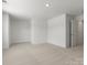 A spacious bedroom featuring neutral carpet, white walls, recessed lighting, and ample natural light at 2022 Puddle Pond Rd, Indian Trail, NC 28079