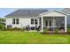 Spacious backyard with a patio, fire pit, manicured lawn and screened-in porch at 2041 Mantle Ridge Dr, Indian Trail, NC 28079
