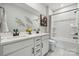 Well-lit bathroom featuring double sinks with black hardware and a tub with a shower at 2041 Mantle Ridge Dr, Indian Trail, NC 28079