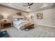 Comfortable bedroom with a decorative tray ceiling, upholstered headboard, and elegant decor at 2041 Mantle Ridge Dr, Indian Trail, NC 28079