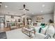 Open-concept living room with modern decor and hardwood floors seamlessly connects to the kitchen and dining area at 2041 Mantle Ridge Dr, Indian Trail, NC 28079
