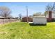Large backyard with grass and a storage shed, ideal for outdoor recreation and storage at 207 N Sims St, Kings Mountain, NC 28086